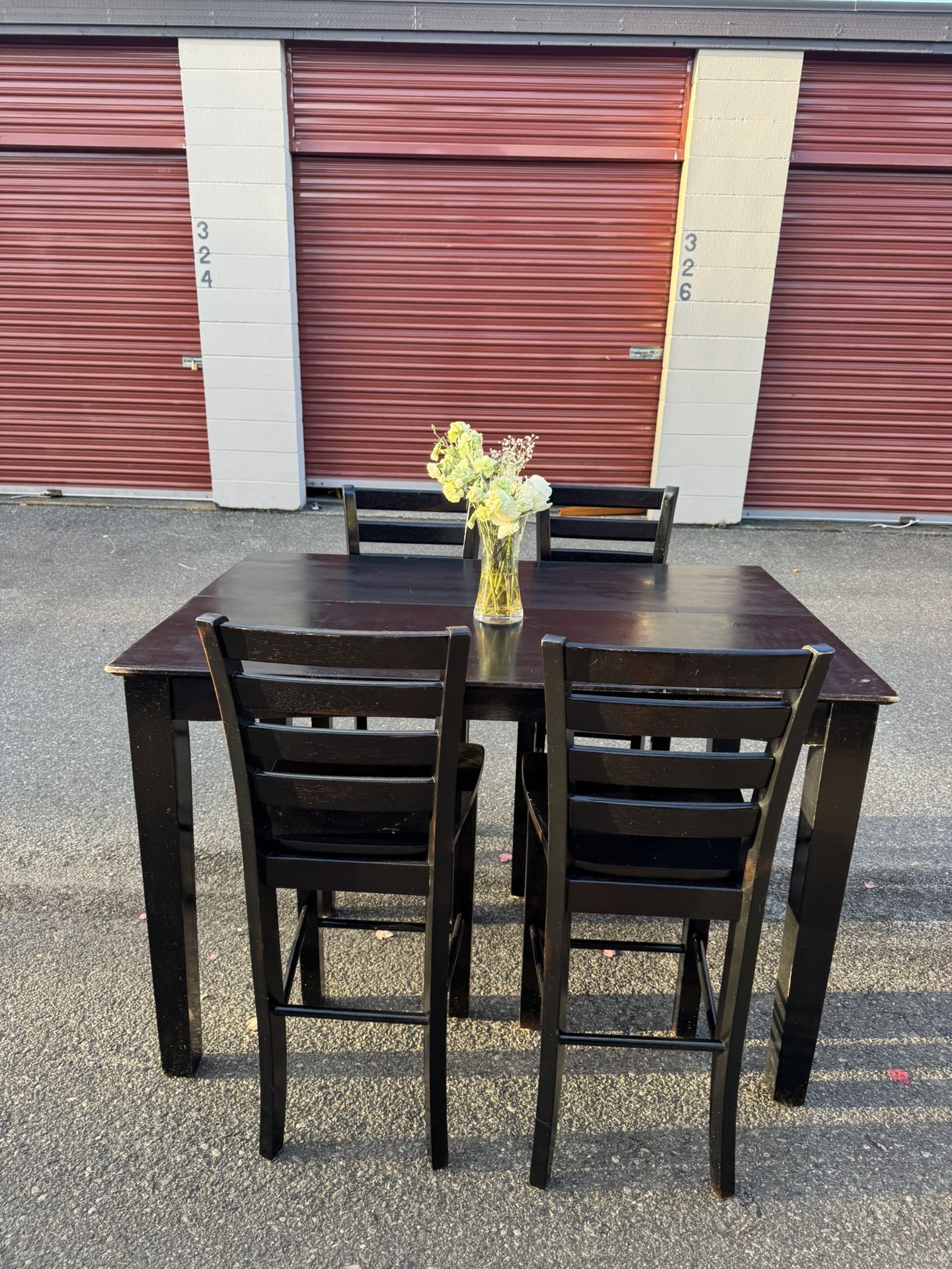 Black wooden high table and four chairs