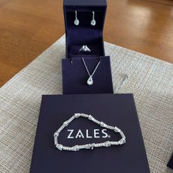 White Sapphire, Earrings, Pendant, Bracelet, Ring. All From Zales Jewelers.