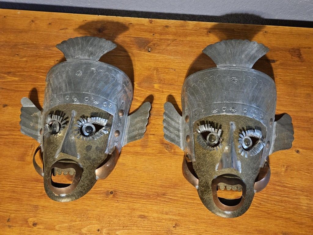 Pair of Mexican Folk Art Metal Mask Brass Copper Silver Tones Glass Eyes Wall Art Mid Century This stunning pair of Mexican folk art metal masks