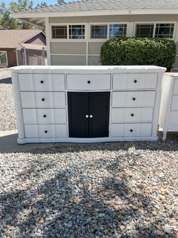 Freshly sanded and painted nine drawer dresser with extra space in the center behind the black doors , it could be a dresser sideboard buffet , whatev