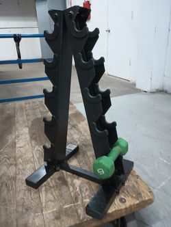 Sturdy black metal A-frame dumbbell rack has a five-tier design to store up to five pairs of weights.
This vertical stand helps organize gym equipmen