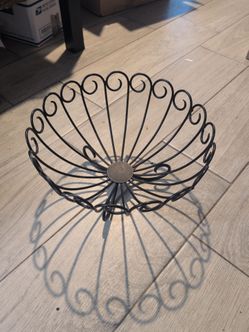 vintage-style black wrought iron wire fruit basket.