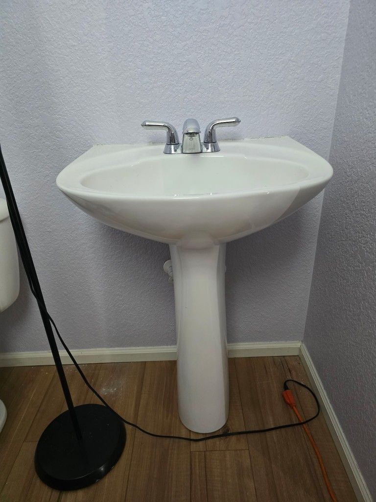 Pedestal sink with faucet