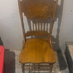 Set of 4 Brown wooden chairs.
