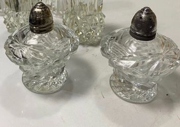 Vintage Set of salt and pepper shakers with silver tops.