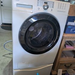 Kenmore LG Front loading washer/washing machine and dryer on pedestals