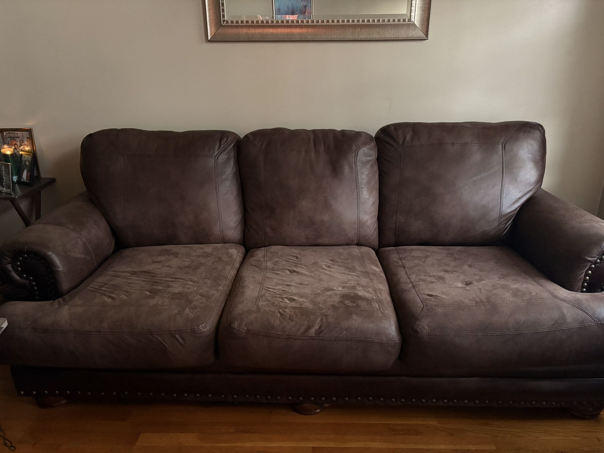 Beautiful brown leather sofa with metal detailing