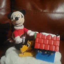 vintage Disney animated holiday tabletop decoration featuring Mickey Mouse and Pluto. 
Characters: Mickey Mouse in a Santa suit and Pluto in a Santa h