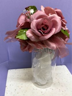 • Artificial floral arrangement, potentially a corsage.