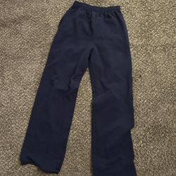 Navy blue sweatpants with elastic waistband and pockets