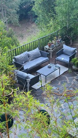 Brand new high quality 4 pc Modern patio set including water resistant cushions Sofa , 2 chairs and table New in box No assembly needed only the ta