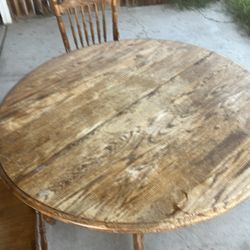 Round oak table Saturday and solid in fair condition Chairs reinforced and in excellent condition . Make  a great family addition!