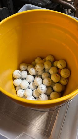 Bucket of Titleist golf balls