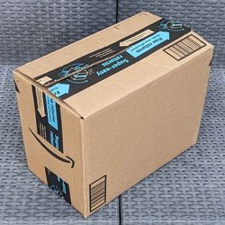 Clean small size cardboard box with foam packing peanuts for shipping moving or storage