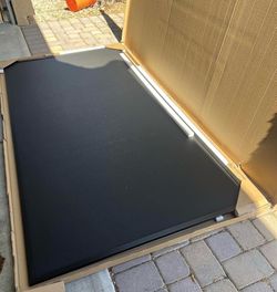 Wood framed black cork board