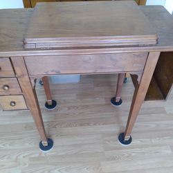 Antique wooden sewing machine cabinet.  No sewing machine.