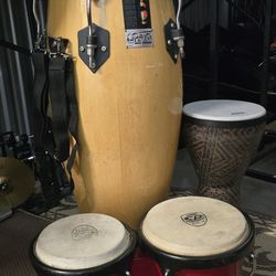 Versatile percussion bundle includes one large Toca Players Series wood conga with shoulder strap, a pair of red CP Cosmic Percussion bongos, $150 Obo