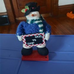 Frosty the snowman decorations holding a sign days to shop sign $10 