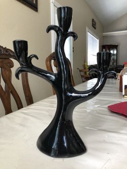 Black candle holder!! It’s a bit scratched in the back!! Abt 13 inches