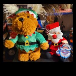 CHRISTMAS HOLIDAY ITEMS (2) BATTERY OPERATED, NEW SHAKE & LAUGH SANTA, DOG DRESSED AS A ELF, SINGING WHILE HIS EARS CLAP BACK & FORTH, FIRM.