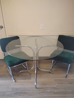 Glass dining set with velvet green chairs