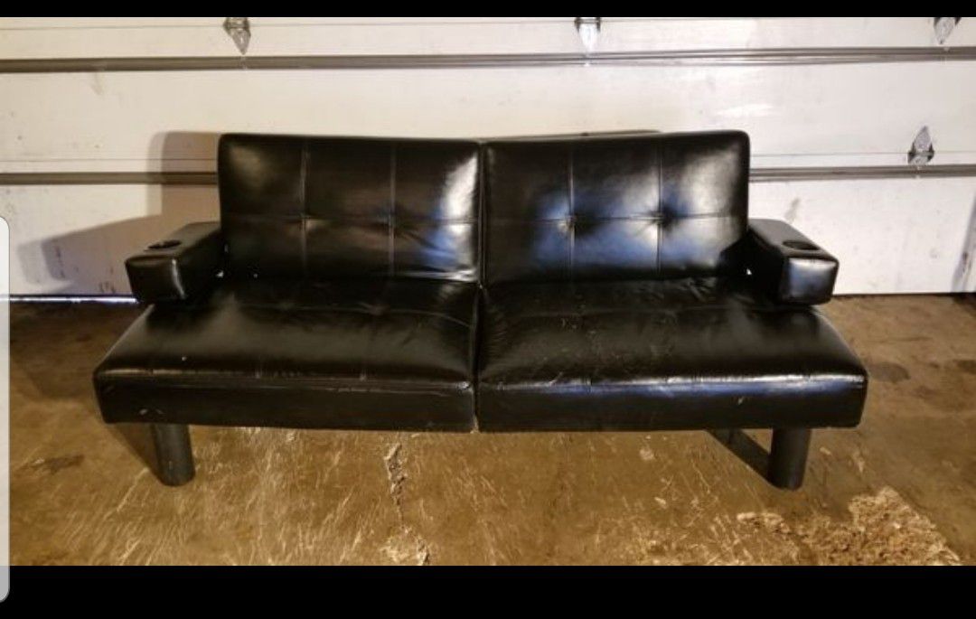 Futon, Sofa Leather Black (pre-owned/used) Unit in decent, usable condition. Has some cracks (see images) in leather, but still very useable.