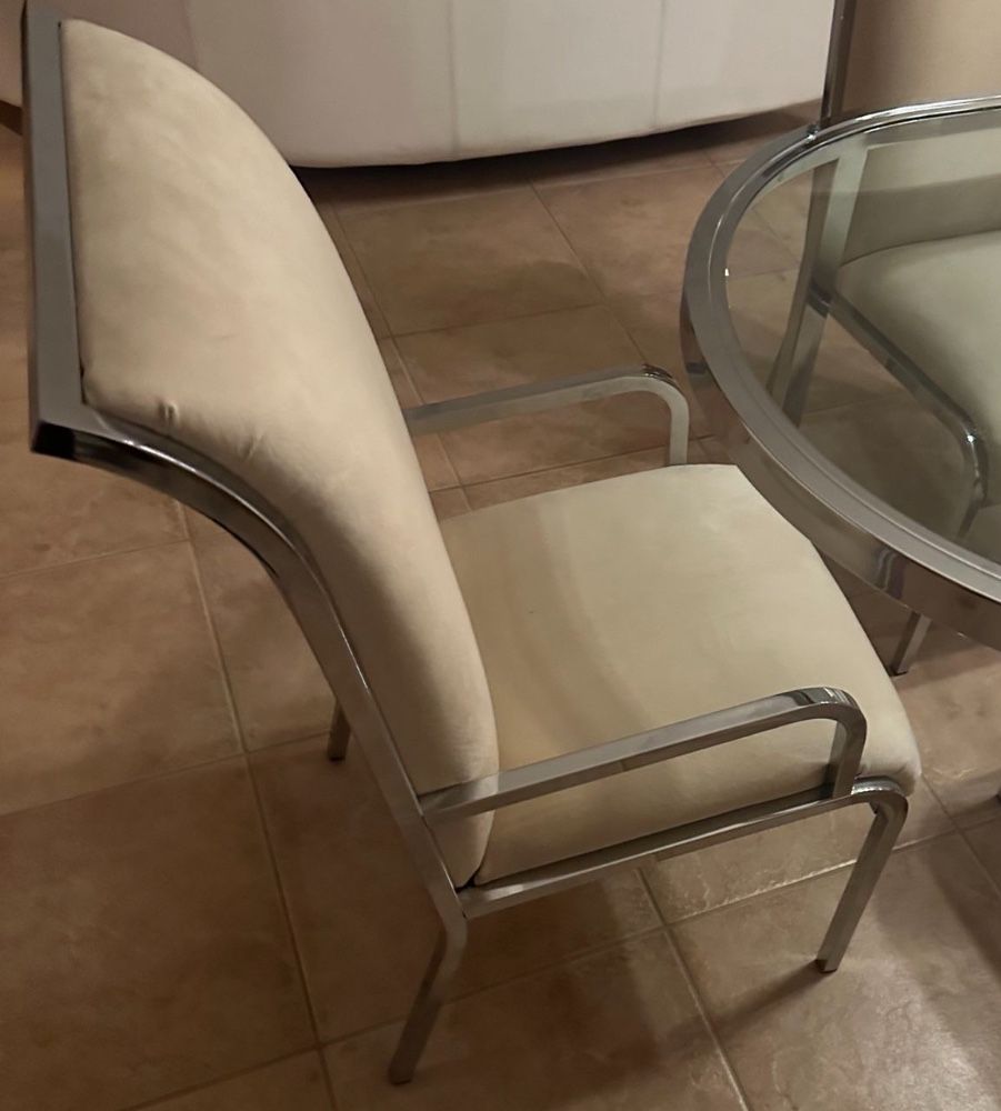 8 Chairs elegant cream-colored chairs with chrome accents.