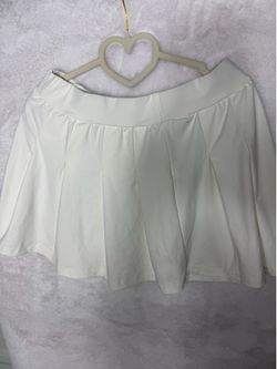 Three skirts, two blacks, white white