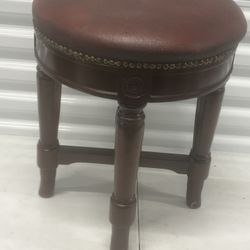 The vintage 14” small brown round foot stool is a charming addition to any home, especially for kids. With a red vinyl material and compact size of 14