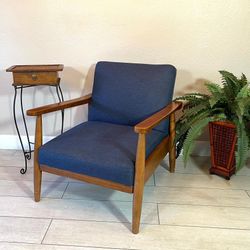Mid Century  Reclining Accent Chair with side table and plant.