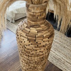 Wooden floor vase filled with dried pampas grass