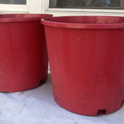 Two red planter buckets 