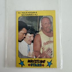 1986 Monty Gum Wrestling Stars trading card #51 features Hulk Hogan, Muhammad Ali, and Liberace.