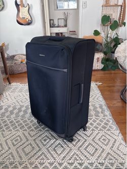 AmazonBasics large rolling soft-side suitcase.
