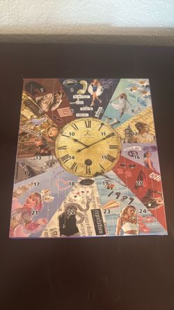 NEW This is a Taylor Swift-themed 24-day Christmas advent calendar, designed with a central clock motif and numbered daily doors.