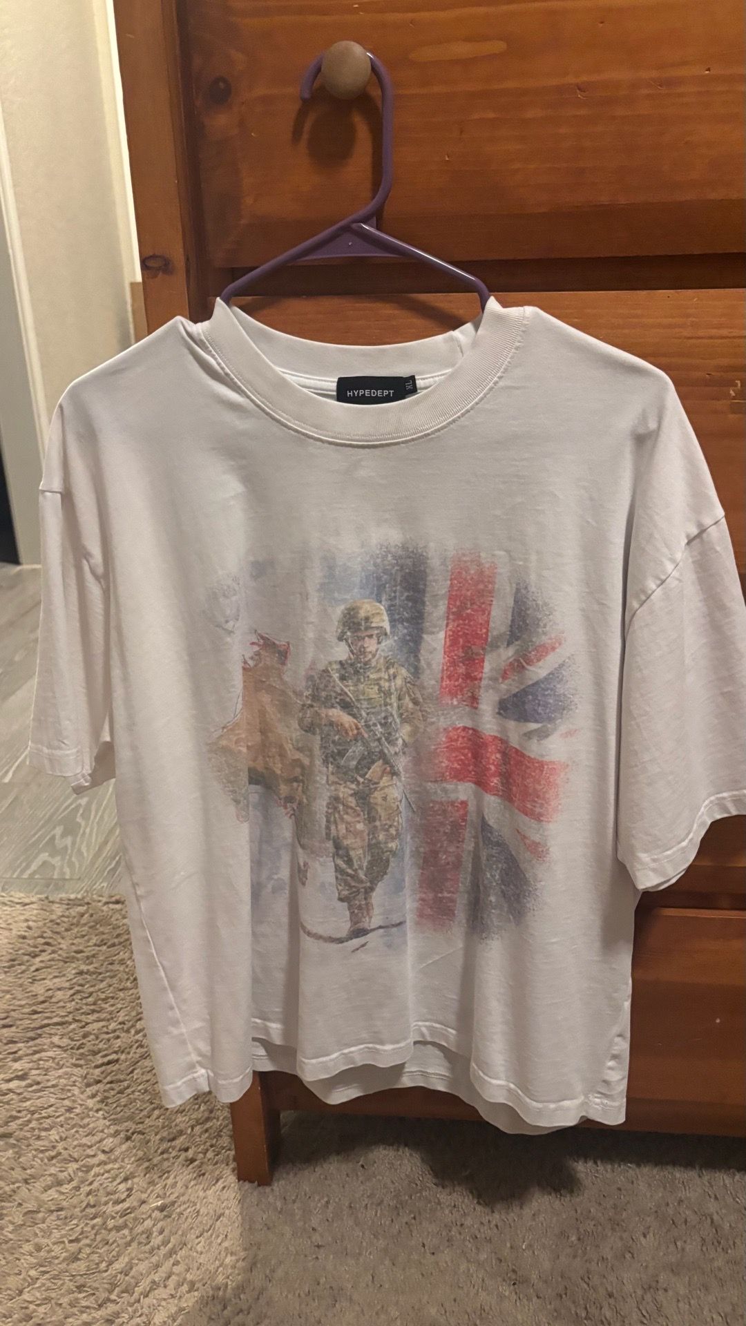 This white graphic t-shirt is from the brand Hypedept and features a distressed soldier graphic in front of a Union Jack flag. Cropped