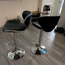 Black adjustable bar stools (sold as a pair)
