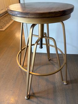 Four adjustable gold barstools