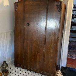 Armoire With Shelves And Mirror On The Back Of The Door