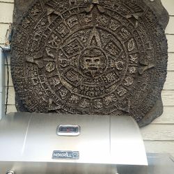 Aztec calendar made of newspaper, 3x3 feet, with a view of rock, 2 inches thick, with plywood on the back for strength.
