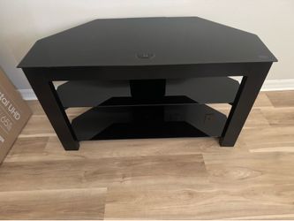 Black TV stand with glass shelves