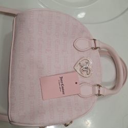 Juicy Couture Flawless Dome Satchel in powder light pink faux leather with silver-toned hardware. 