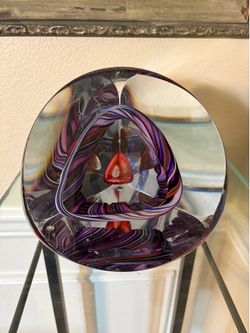 Clear Art glass paperweight with internal abstract purple and pink swirled ribbon design and an orange red central prism 7”x7”