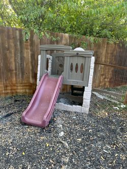 children’s outdoor playset/playhouse with a slide