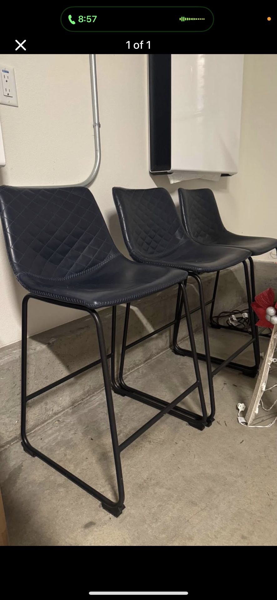 Three navy and black counter height chairs