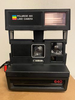 Vintage Polaroid Sun 640 camera with strap
