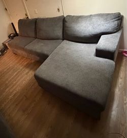 L shaped charcoal colored couch
