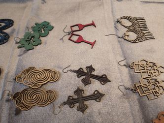 These handmade wooden earrings feature laser-cut designs