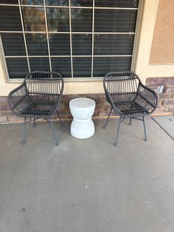 2 black patio wicker chairs and side table