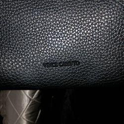 This is a black pebbled leather Vince Camuto tote bag. 
